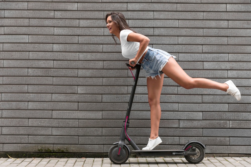 side-view-happy-woman-posing-electric-scooter.jpg