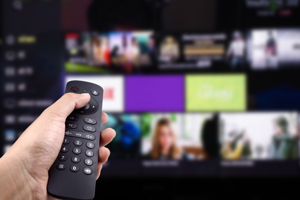 hand-holding-tv-remote-control-with-smart-tv.jpg