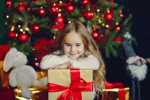 little-girl-near-christmas-trre.jpg