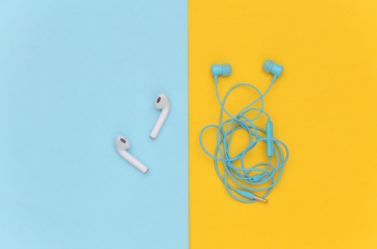 wireless-earphones-wired-tangled-headphones-yellow-background-top-view-flat-lay.jpg