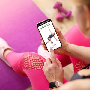 woman-uses-fitness-app-her-phone-working-out-home.jpg
